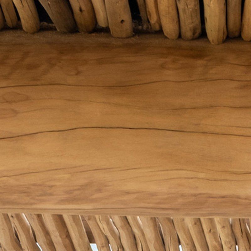 A round log beam under a ceiling of loose sticks.